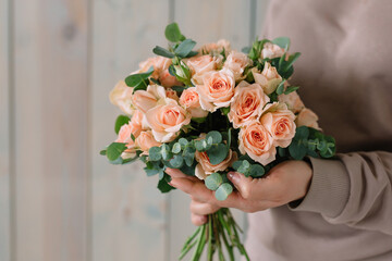 Amazing bouquet of roses in a girl's hands for a birthday