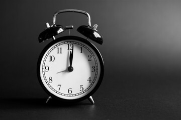 Alarm clock on a black background.