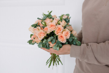 Amazing bouquet of roses in a girl's hands for a birthday