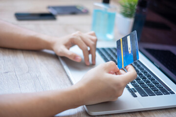 woman holding credit card and using laptop for online shopping while making order at home office. business, lifestyle, technology, ecommerce, digital banking and online payment concept