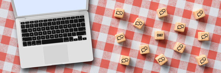 many cubes with speech bubble icons and laptop on kitchen table background