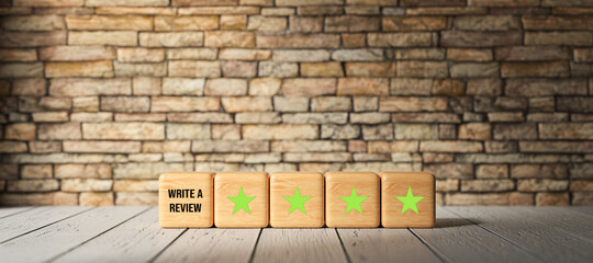 Fototapeta na wymiar cubes with stars and message WRITE A REVIEW in front of a brick wall on wooden background