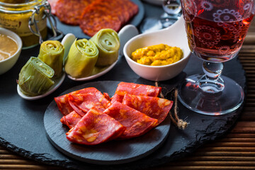 Assortment of tapas and antipasti on black background