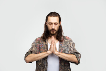 Please! Hand gesture prayer, asks for something higher powers, hope and gratitude. Hipster traveler stylish carefree man on a white studio background, people lifestyle