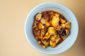 Grilled squid mix with spicy seafood sauce in bowl