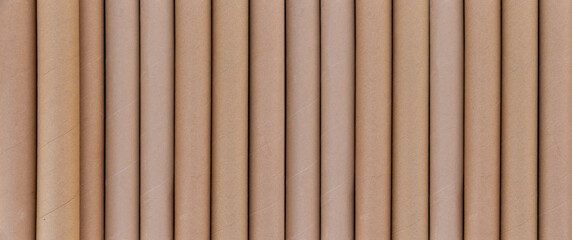 Detail of many cardboard tubes stacked vertically. Space for text. Concept of industry and recycling. 