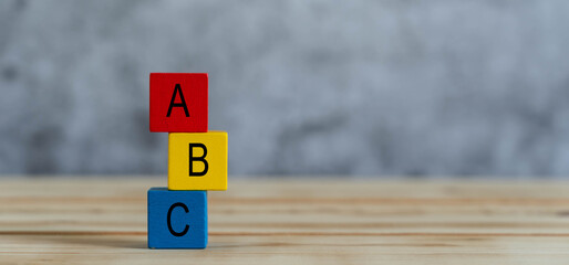 Close up of colorful A B C  letters alphabet on cube blocks on wooden background .Business concept...