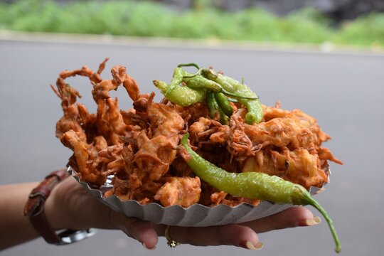 Famous food called "kanda bhaji" in India with green chilies.