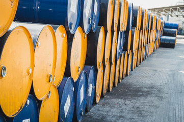 Industry oil barrels or chemical drums stacked up.chemical tank.container of  barrels of hydrocarbons.hazardous waste of black and blue tank oil.