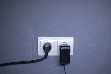 Sockets for electrical appliances on a light gray wall. a multifunction outlet. High quality photo