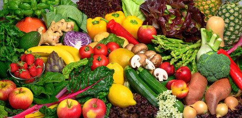 Arranged pile of fruits and vegetables in many appetizing colors, inviting to lead a healthy plant-based lifestyle and self-care