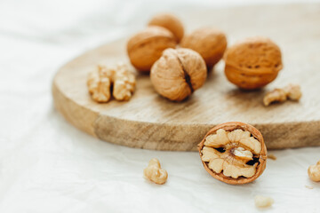 Obraz na płótnie Canvas Unpeeled walnuts on wooden surface, closeup. Food photo. Selective focus.