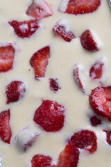 filled frame background wallpaper shot of strawberries on the surface of a milky white vanilla cheese cake cream liquid