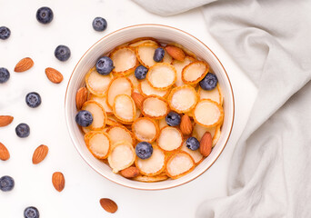 tiny pancake cereal breakfast with fresh berries and almonds