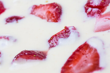 filled frame background wallpaper shot of strawberries on the surface of a milky white vanilla cheese cake cream liquid