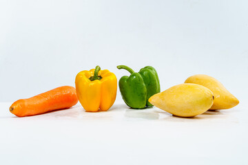 Mix Fruits for Healthy Eating, Carrot, Bell Pepper and Mangos with Water Drop on Isolated White Background.