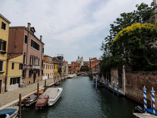 Fototapeta na wymiar Canal waterway, bridge and house with tree in Venice Italy