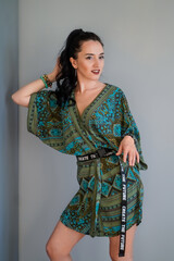 the girl in a housecoat straightens her hair The words on the belt - create the future