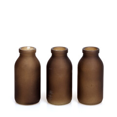 Decorative glass brown bottles isolated on white background