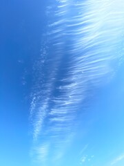 feathery clouds streaking across a rich blue sky