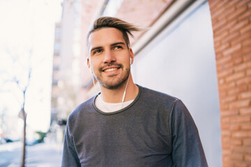 Man listening to music with earphones.