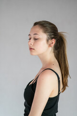 Profile portrait of a pretty teenage girl with ponytail hair