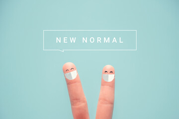 Fingers wearing protective mask and social distancing. with NEW NORMAL word, Adapting to new life...