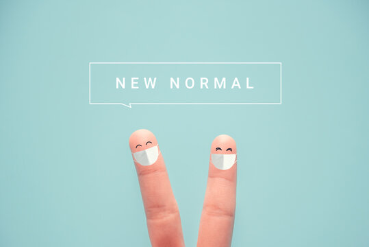 Fingers wearing protective mask and social distancing. with NEW NORMAL word, Adapting to new life or business post-lockdown after coronavirus pandemic. 