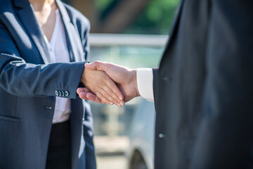 Male and female hands in a handshake.