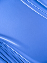Smooth elegant wavy blue satin silk luxury cloth fabric texture, abstract background design.
