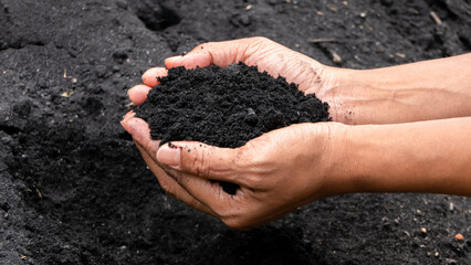 The hand that is holding the soil used for cultivation