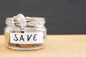Coins in a glass jar for saving money financial concept