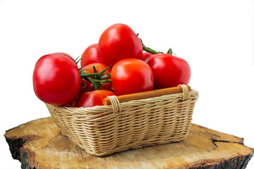 Fresh organic tomatoes in a basket isolated on white.. Close up.