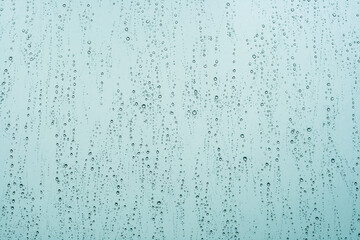 raindrops in a window, blue abstract background