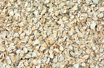  Pile of oat-flakes, background of uncooked oats. Texture of raw oatmeal.