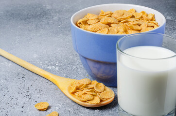 Corn flakes in a plate and milk in a glass. Healthy breakfast. Copy space