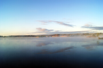 Beautiful morning by the lake in a fog of fog.