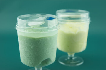 two plastic glasses with ice cream closeup