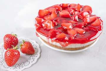 cheesecake with strawberry and fresh berries on gray table