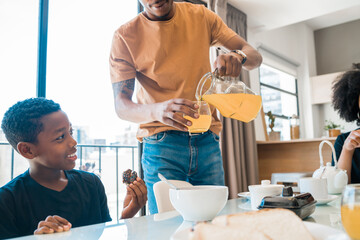 Family having breakfast together at home.