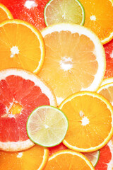Mix of citrus slices. Colorful tropical fruit background. Top view.