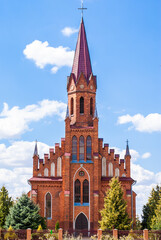 Fototapeta na wymiar Roman Catholic Church on bright summer day. Neo-gothic Architecture style. Stock photo