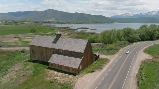 Aerial: Old Historic Tate Barn and highway. Midway, Utah, USA