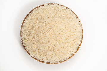 Raw rice in a brown bowl Isolated on a white background. View from above