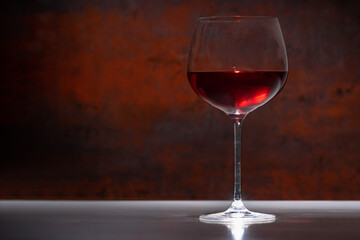 Glass or red wine against a rustic background