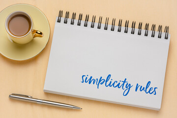 simplicity rules inspirational note in a sketchbook with coffee - design and minimalism concept