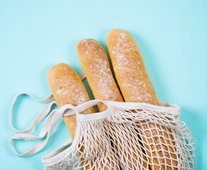 Fresh homemade wheat baguette in an eco bag