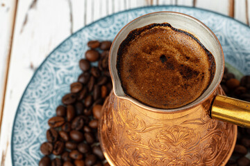 Coffee in copper turk on coffee beans