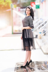 Fototapeta premium Stylish woman in an elegant black outfit