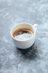 Cup of coffee on rustic wooden background.
